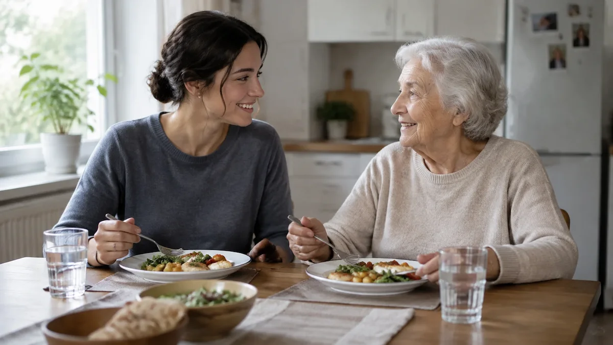 Caregiver and senior sharing a meal during an in-home companion care visit